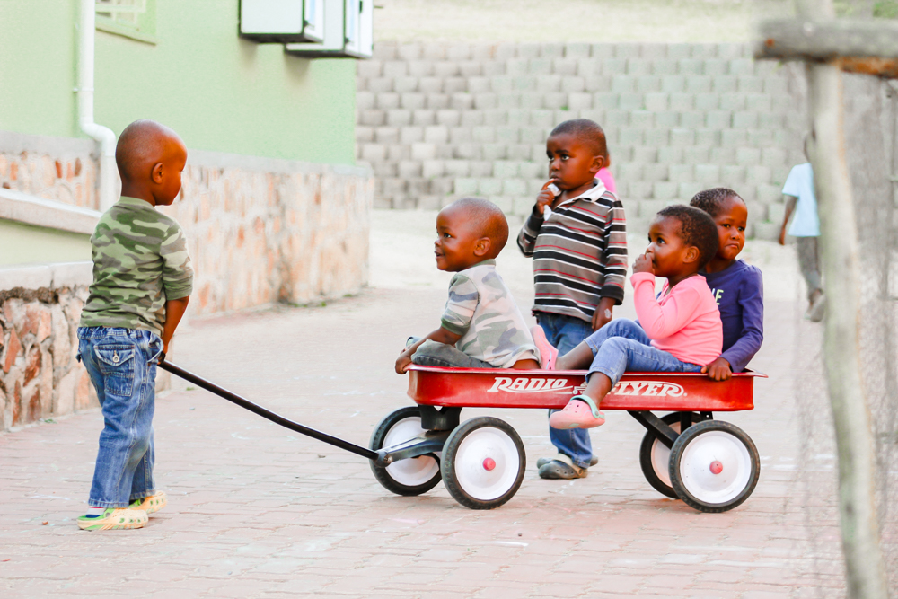 Children riding in a wagon.